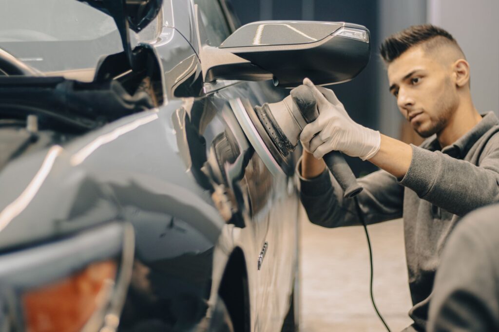 technician performing detailing near me service on a car in Ocala driveway
