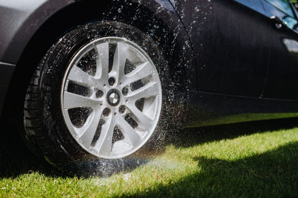 local car detailing company technician cleaning wheels in Marion County driveway