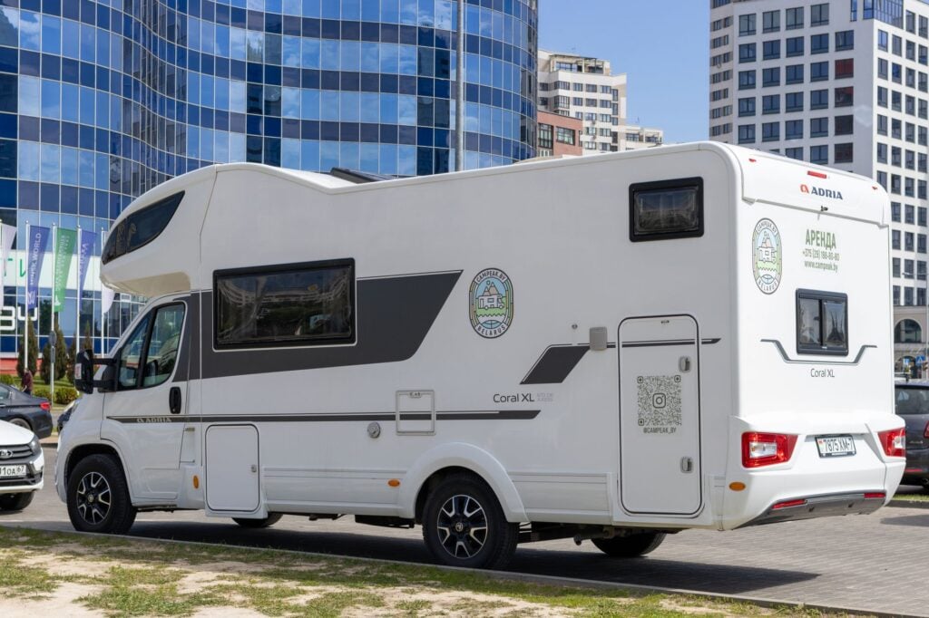 technician performing RV detailing on a motorhome exterior in Ocala