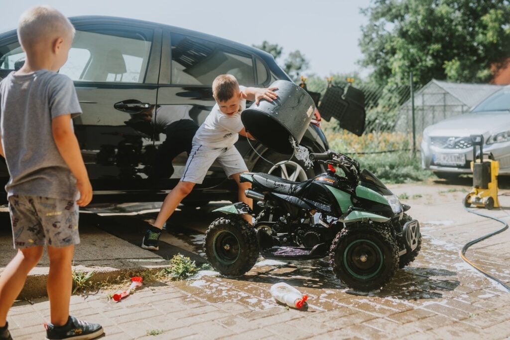 DIY rv wash near me setup with soap bucket and soft brush on driveway