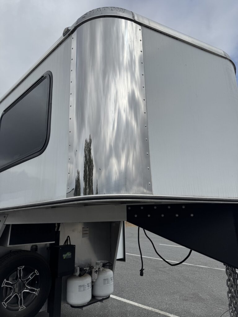 technician performing an aluminum trailer acid wash near me on a horse trailer in Ocala