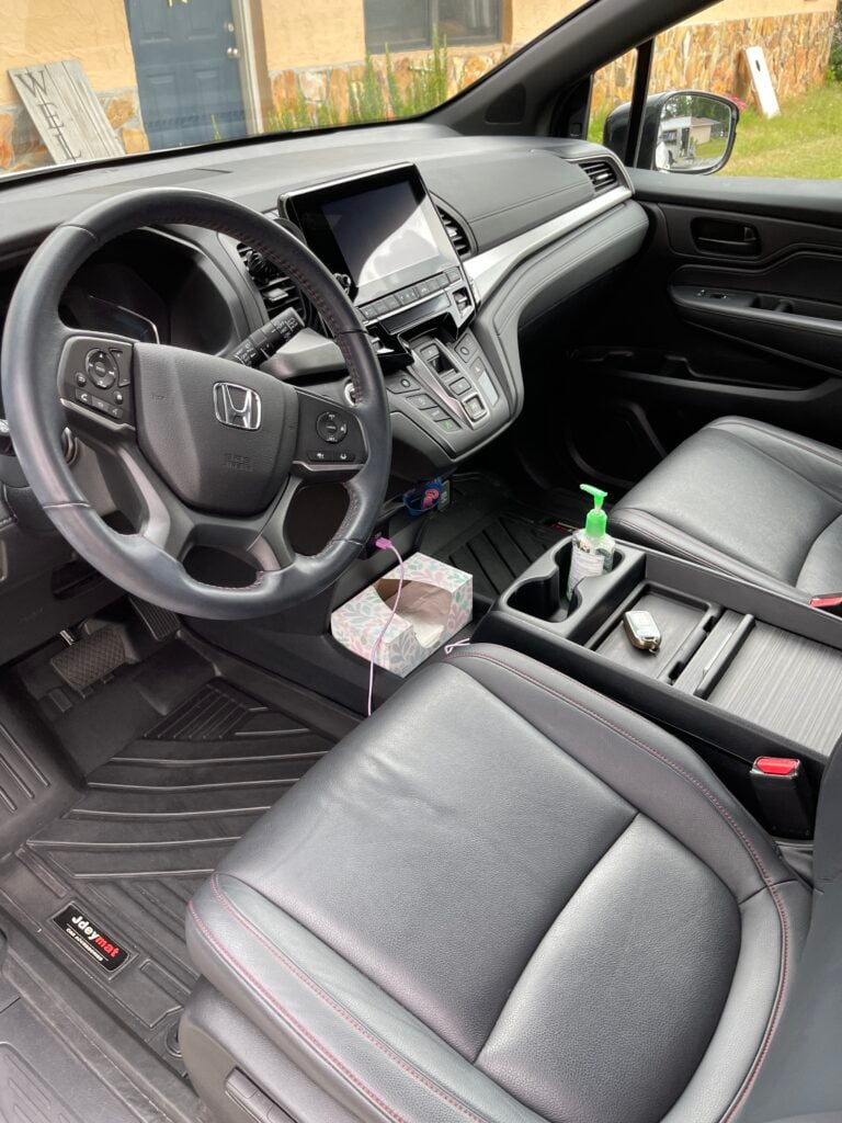 technician performing interior car cleaning inside a sedan in Ocala