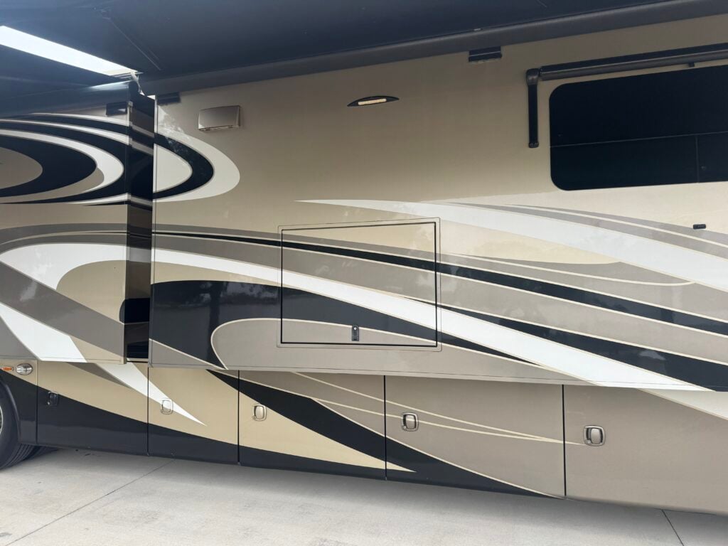 technician performing mobile rv detailing lakeland service on a motorhome exterior