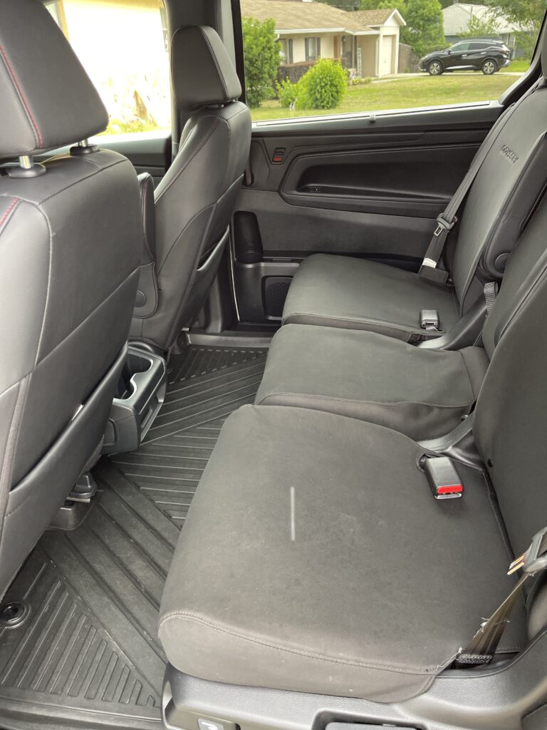Fresh, Spotless Interiors: Ocala's Car Interior Cleaning Guide 1 professional detailer performing car interior cleaning on leather seats in Ocala FL